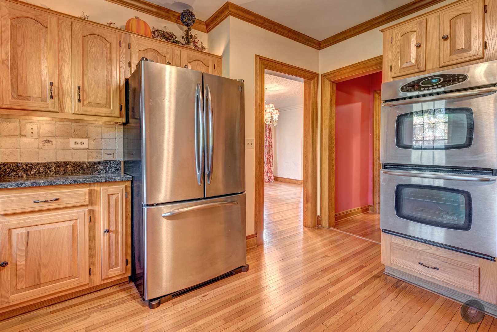 933 North Main Street Glen Ellyn, IL 60137 - Photo 13 of 32 a kitchen with granite countertop wooden floors stainless steel appliances and cabinets