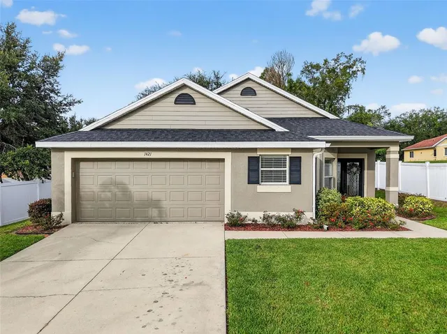 a front view of a house with a garden and yard