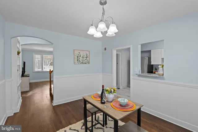 a view of a dining room with furniture wooden floor and a chandelier