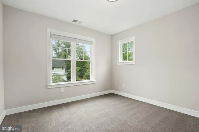 a view of kitchen with white cabinets and wooden floor