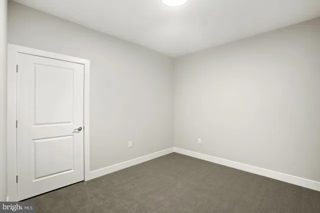 a view of an empty room and closet area