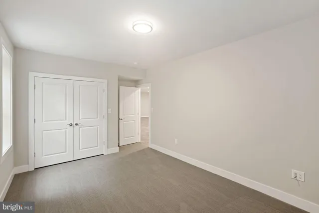 a bathroom with a white toilet sitting next to a white sink and a shower