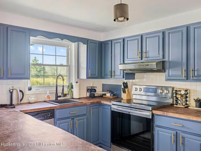 a living room with furniture a flat screen tv and a window