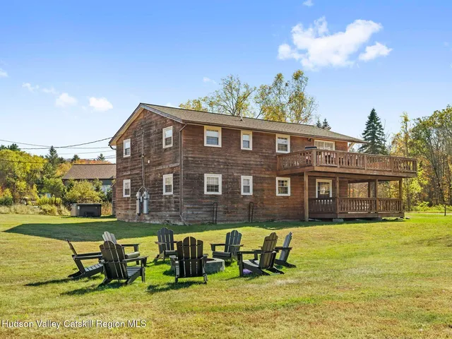 a view of a lake with table and chairs