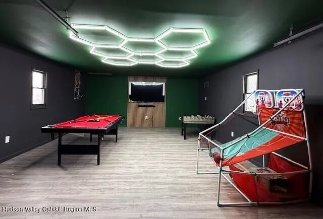 a living room with furniture a flat screen tv and a window