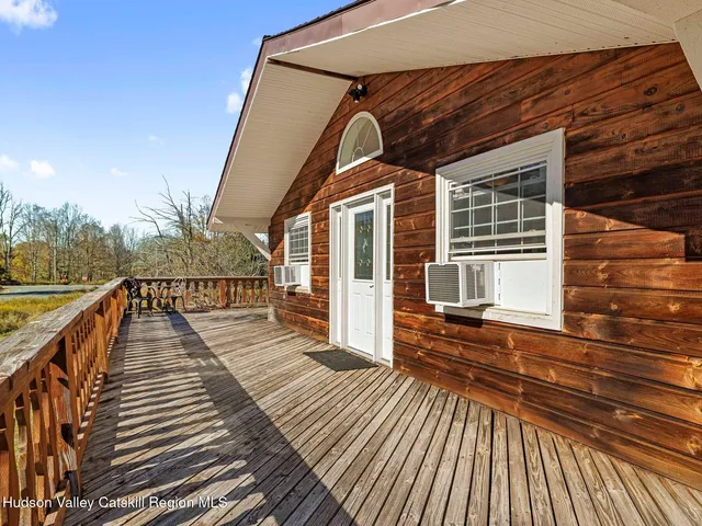 a view of a balcony with wooden floor and outdoor seating