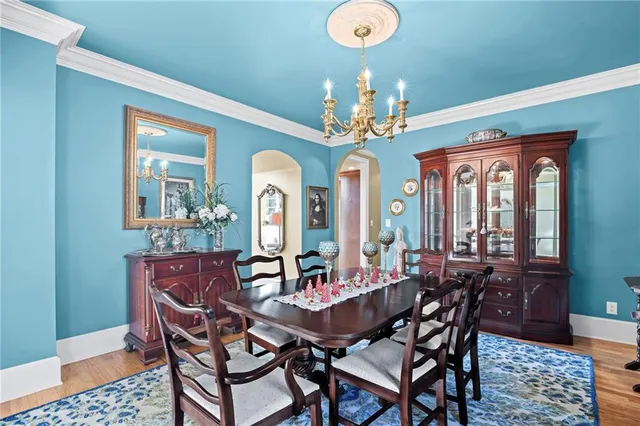 a view of a dining room with furniture and a chandelier
