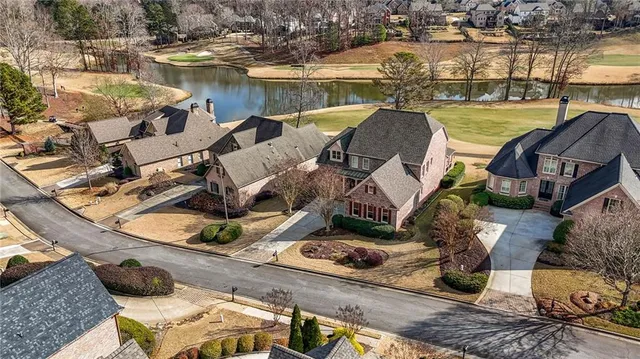 an aerial view of a house with swimming pool and outdoor seating