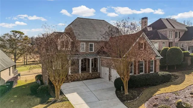 a view of a white house next to a yard
