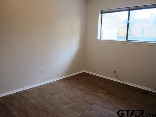 103 Wendy Whitehouse, TX 75791 - Photo 11 of 18 an empty room with wooden floor and windows