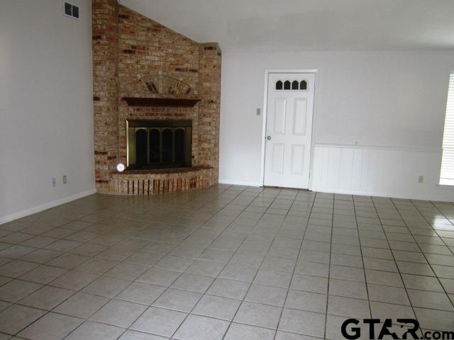 103 Wendy Whitehouse, TX 75791 - Photo 3 of 18 an empty room with windows and fireplace