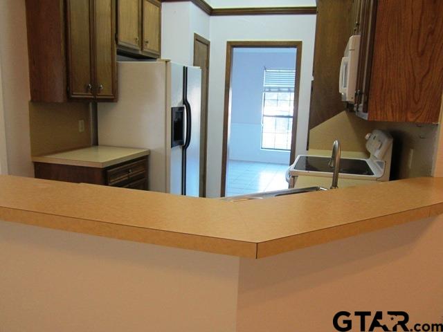 103 Wendy Whitehouse, TX 75791 - Photo 5 of 18 a kitchen with a refrigerator and cabinets