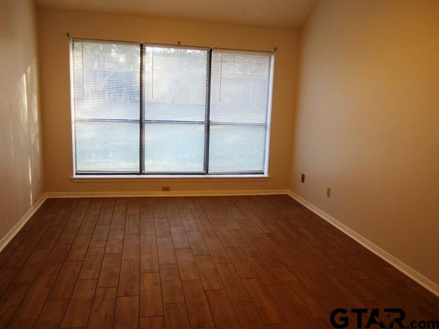 103 Wendy Whitehouse, TX 75791 - Photo 8 of 18 an empty room with wooden floor and windows