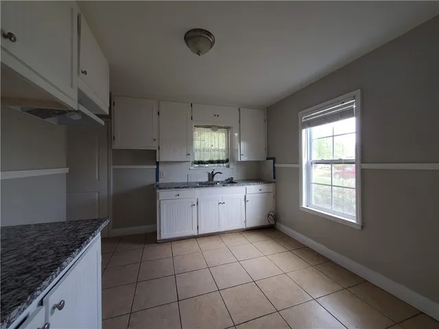 a kitchen with a stove a sink and a refrigerator