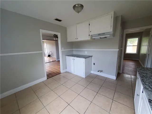 a kitchen with white cabinets