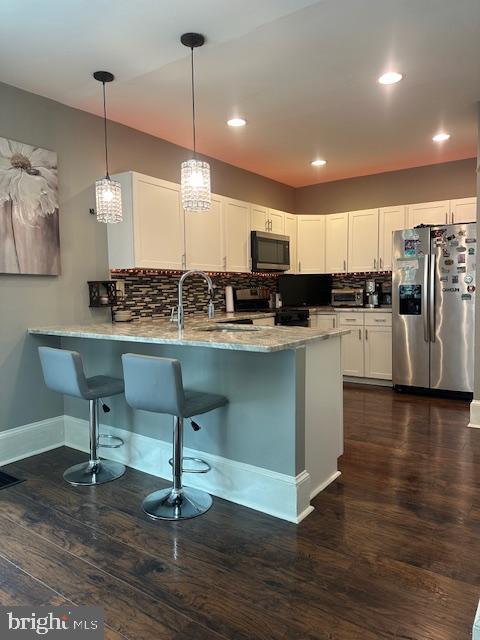 213 Church Street Newfield, NJ 08344 - Photo 15 of 36 a kitchen with stainless steel appliances kitchen island granite countertop a sink a stove a dining table and chairs