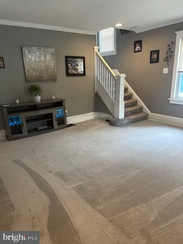 a view of a livingroom with furniture and stairs