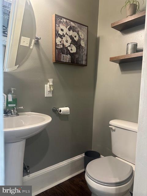 213 Church Street Newfield, NJ 08344 - Photo 28 of 36 a bathroom with a toilet a sink and mirror