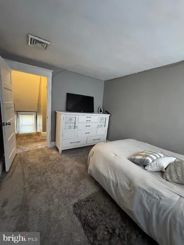 a bedroom with a bed and flat screen tv