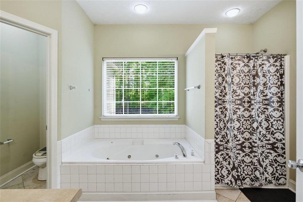 1231 Hillview Road Hampton, GA 30228 - Photo 20 of 49 a bathroom with a bathtub and a shower