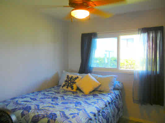 4800 Nonou Road Kapaa, HI 96746 - Photo 17 of 20 a bedroom with a bed and a window