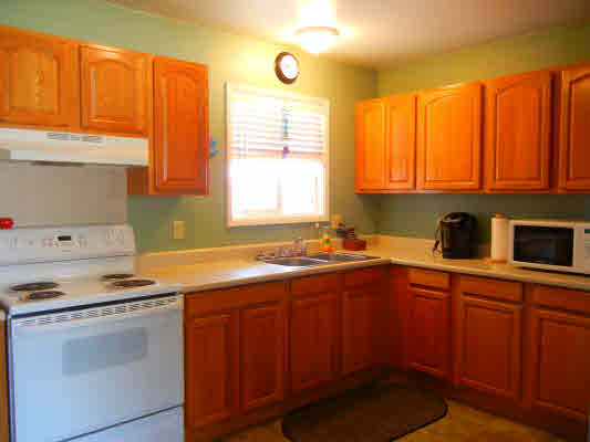 4800 Nonou Road Kapaa, HI 96746 - Photo 5 of 20 a kitchen with stainless steel appliances a stove a sink and a microwave