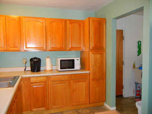 4800 Nonou Road Kapaa, HI 96746 - Photo 6 of 20 a view of kitchen with stainless steel appliances wooden floor and a window