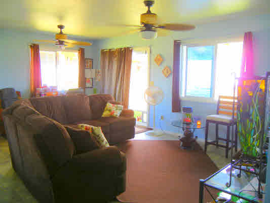 4800 Nonou Road Kapaa, HI 96746 - Photo 8 of 20 a living room with furniture a chandelier and a window