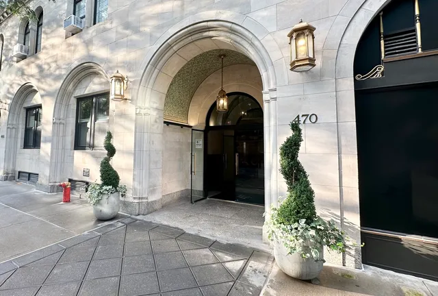 a view of a tall building next to a road