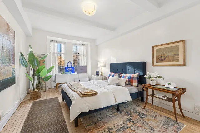 a bed room with a bed and a lamp