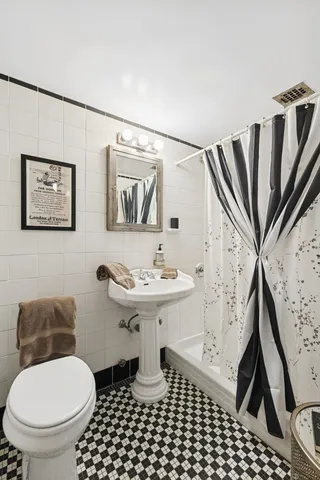 a bedroom with a bed and a potted plant