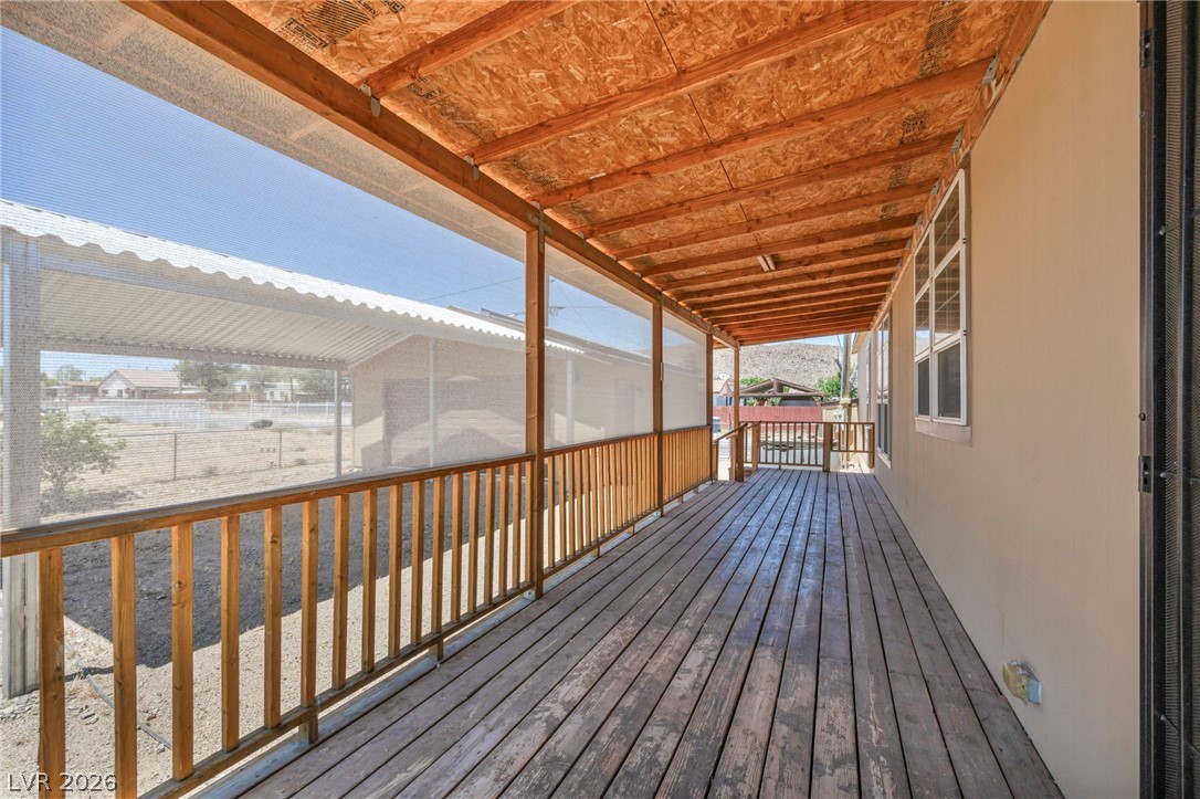 225 California Street Searchlight, NV 89046 - Photo 27 of 64 A spacious covered porch with exposed wood framing and a sturdy wooden deck invites outdoor enjoyment.