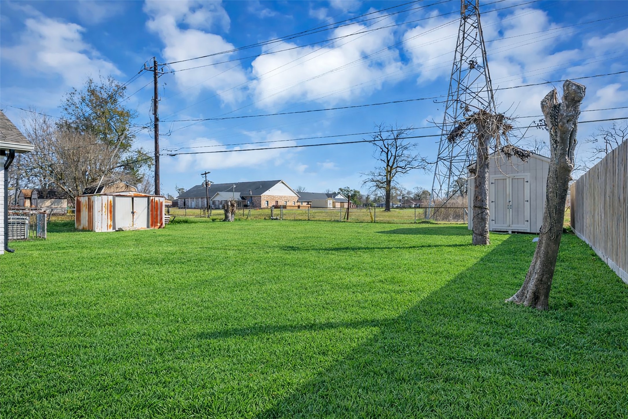 10730 Filey Lane Houston, TX 77013 - Photo 23 of 25 Spacious backyard with a shed and a fenced yard. Ideal for outdoor activities and gardening.