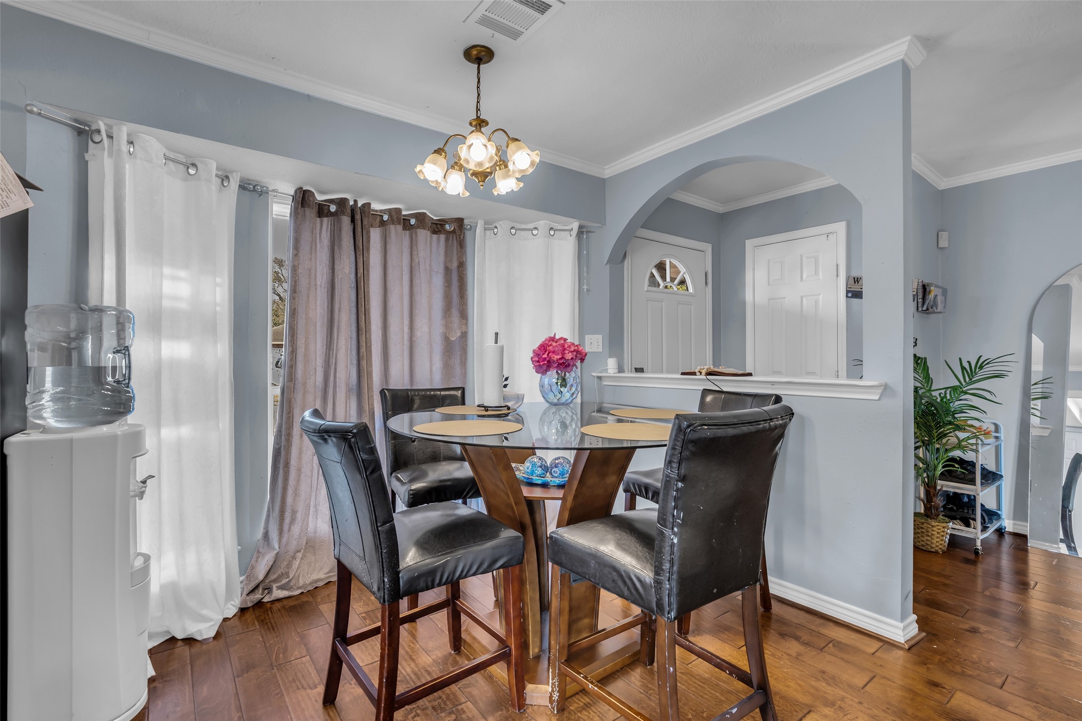 10730 Filey Lane Houston, TX 77013 - Photo 5 of 25 This cozy dining area is filled with natural light. An elegant light fixture hangs overhead, and an archway leads to the entrance, adding charm to the space.