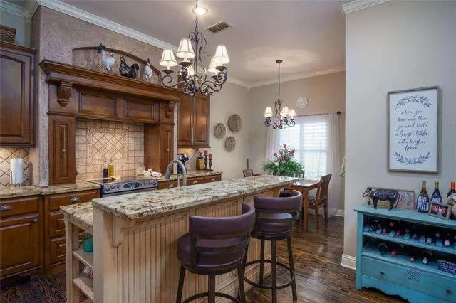 a view of a dining room with furniture and a chandelier