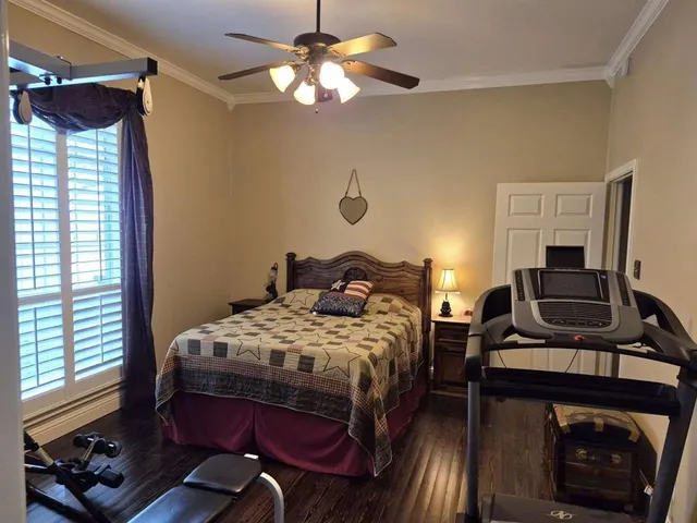 a bedroom with a bed dresser and a window
