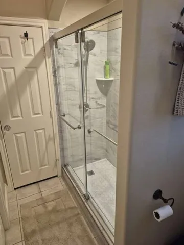 a bathroom with a glass shower door