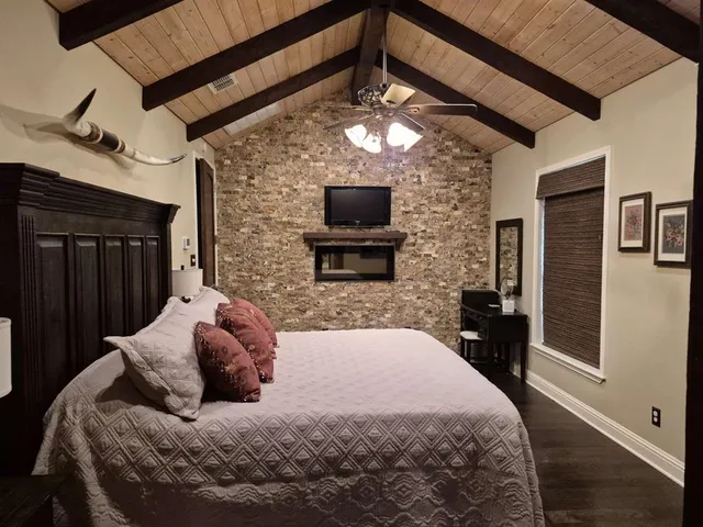 a bedroom with a bed and a flat screen tv
