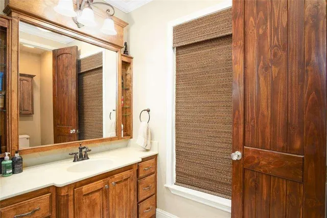 a bathroom with a granite countertop sink and a mirror