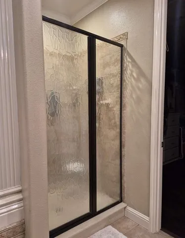 a bathroom with a glass shower door