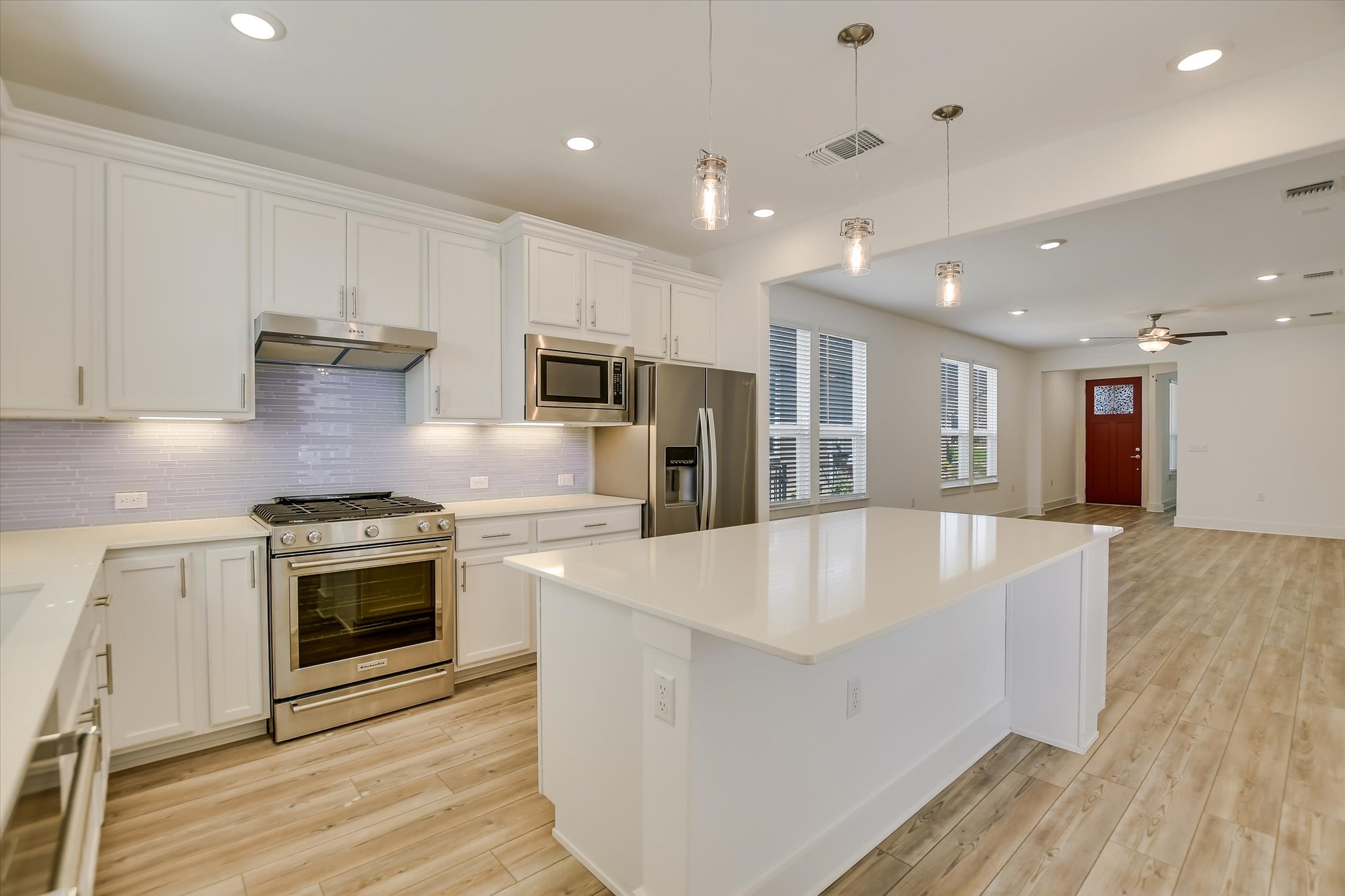 702 Kitty Hawk Road Georgetown, TX 78633 - Photo 20 of 20 a large kitchen with stainless steel appliances granite countertop a stove a sink and a refrigerator