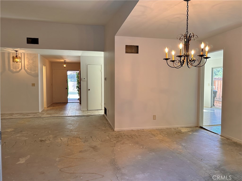 23712 Highlander Road West Hills, CA 91307 - Photo 6 of 21 a view of a livingroom with a chandelier fan and kitchen view