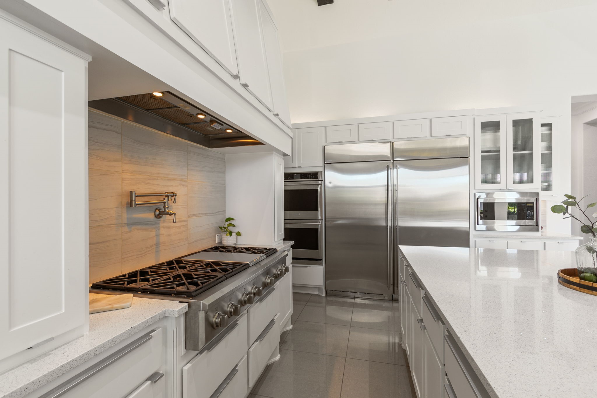 28518 Hoffman Spring Lane Fulshear, TX 77441 - Photo 11 of 50 Close up view of high end six burner cooktop, double ovens and the stainless steel refrigerator.