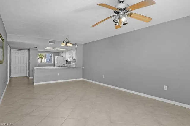 a view of a kitchen with a sink and a refrigerator