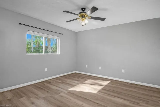 wooden floor in an empty room with a window