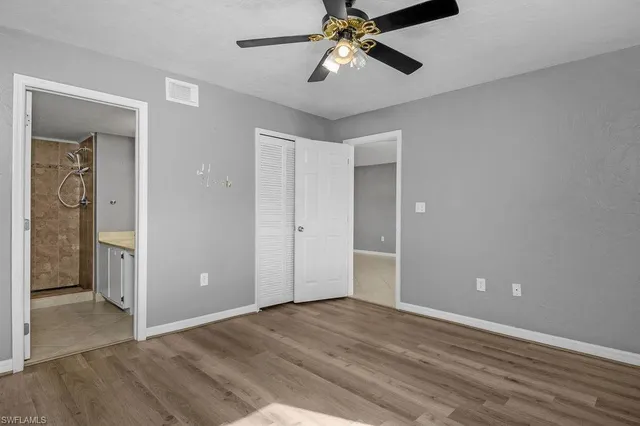 a view of empty room with wooden floor