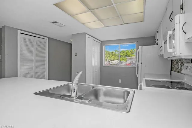 a kitchen with stainless steel appliances granite countertop a sink and a granite counter tops