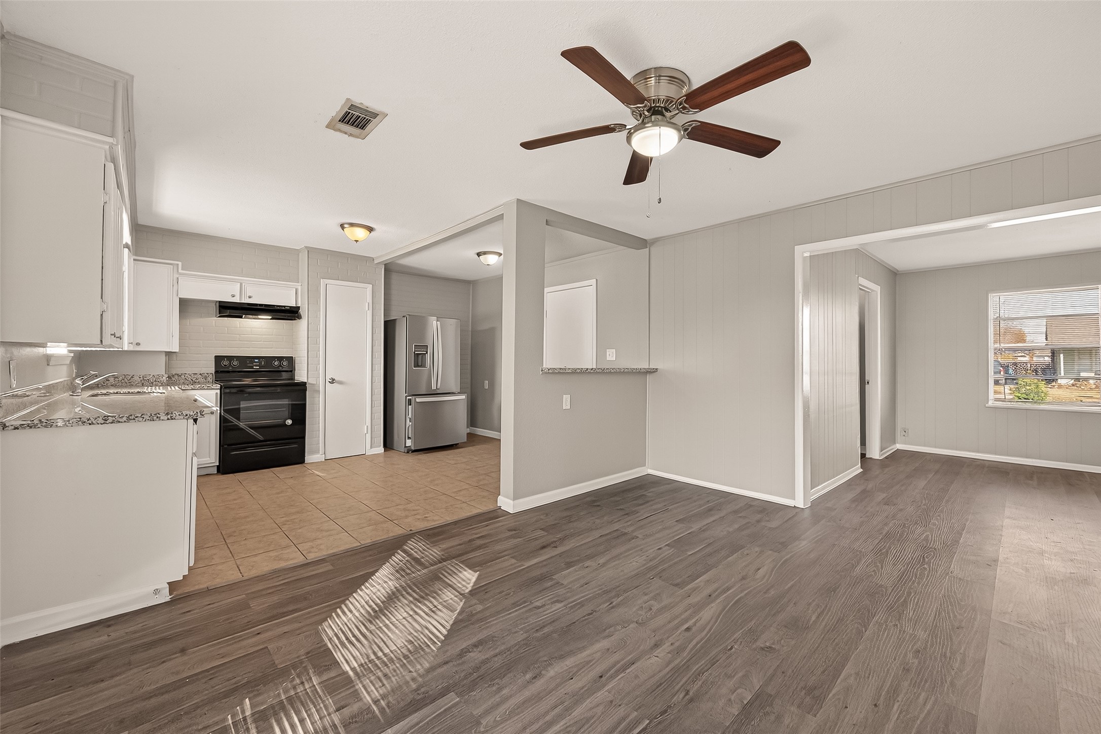 3102 Hays Street Pasadena, TX 77503 - Photo 11 of 25 a view of a kitchen with wooden floor and a kitchen