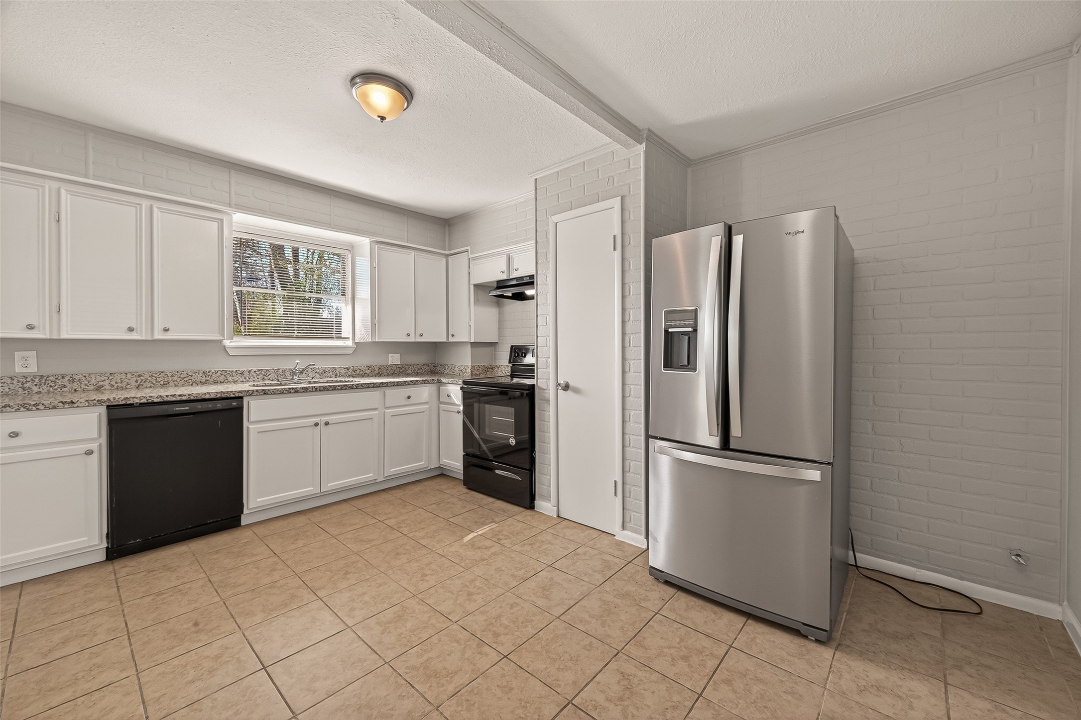 3102 Hays Street Pasadena, TX 77503 - Photo 18 of 25 a kitchen with a refrigerator sink and cabinets