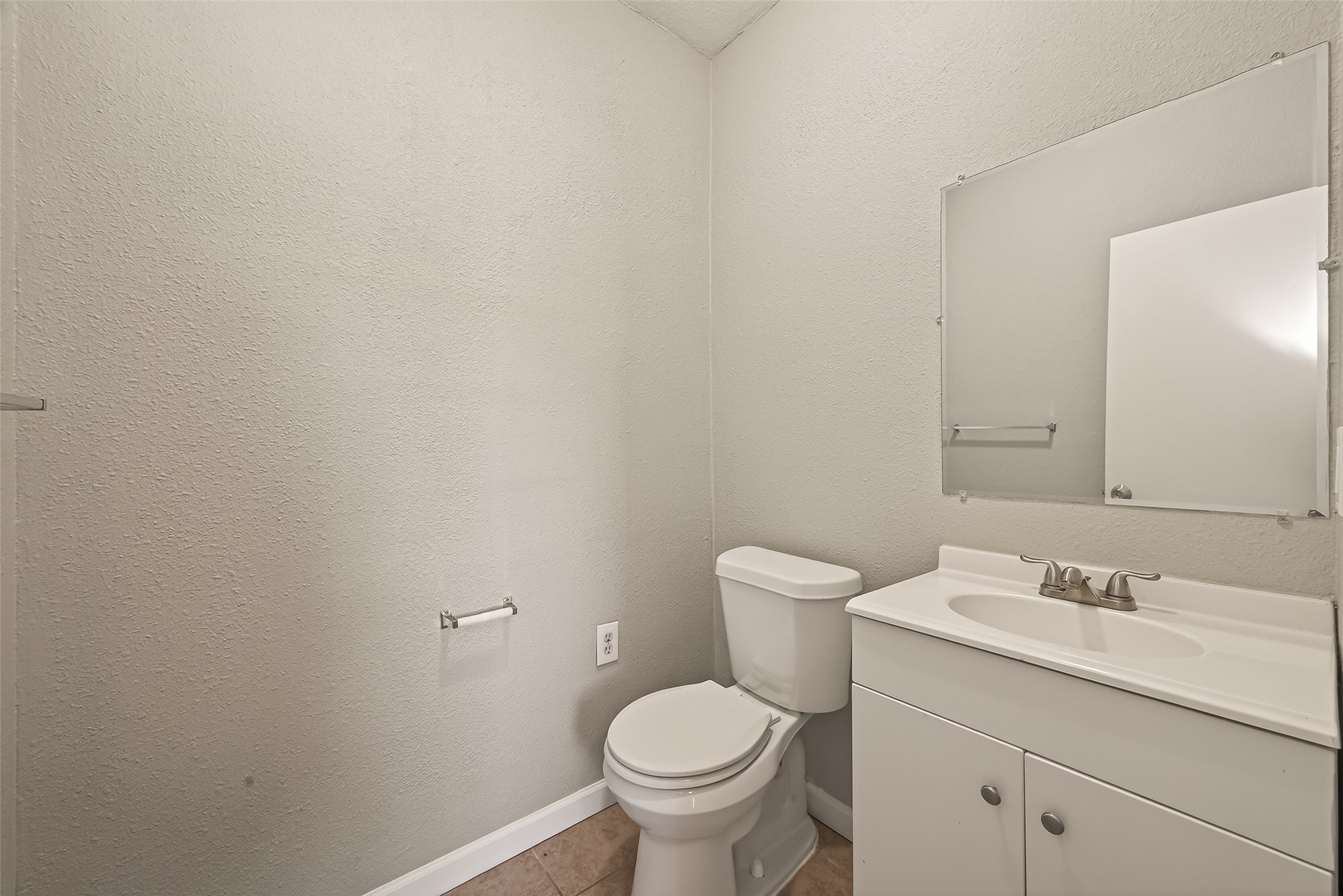 3102 Hays Street Pasadena, TX 77503 - Photo 21 of 25 a bathroom with a toilet sink and mirror